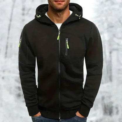 Model wearing the hoodie in black with bright lime green zip pulls and drawcords, set against a snowy woodland backdrop. 7