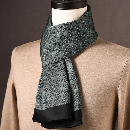 Dark green silk scarf with a fine woven-look geometric print and a plain black border, draped on a mannequin. 23