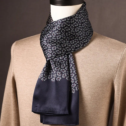 Navy silk scarf with a small white paisley pattern fading into a plain navy end, worn on a mannequin. 26