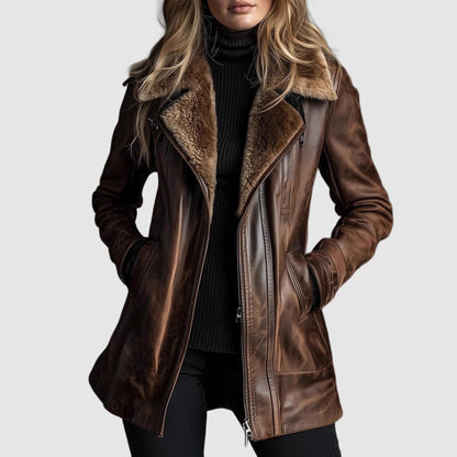 Model wearing the brown leather jacket open at the front over a black roll-neck, hands in pockets 1