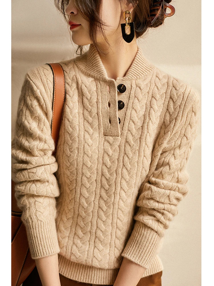 Close-up of the beige cable-knit sweater on a model, showing the buttoned placket, ribbed collar, statement earrings and brown bag strap. 11
