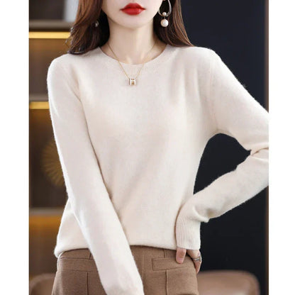 Model wearing the jumper in cream with brown trousers, one hand on her hip 18