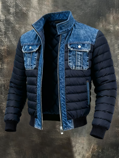Full front view of the unzipped jacket, with navy padded body and sleeves, blue denim collar, yoke and chest pockets, and ribbed cuffs. 1