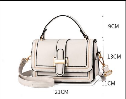 Cream bag front view with measurement lines marked for handle drop, height, depth and width, plus gold clasp and strap. 9