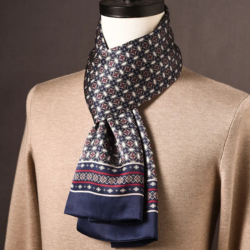 Navy silk scarf with a red and white star-and-oval pattern and a diamond-motif border, draped round a mannequin in a beige jumper. 21