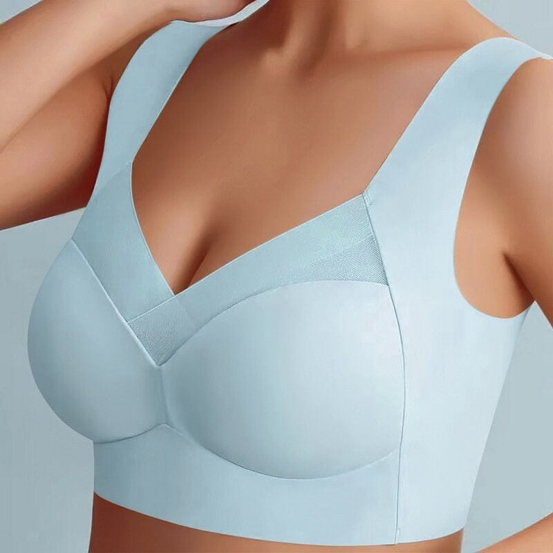Model wearing the bra in pale blue, front view with one hand raised 3