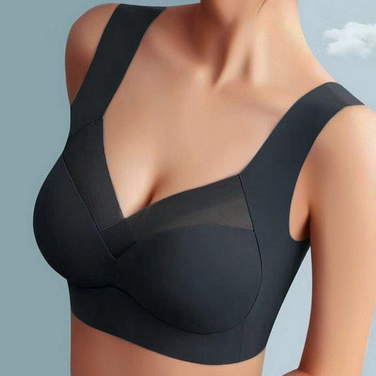 Model wearing the bra in black, front view with mesh panels and wide straps 1