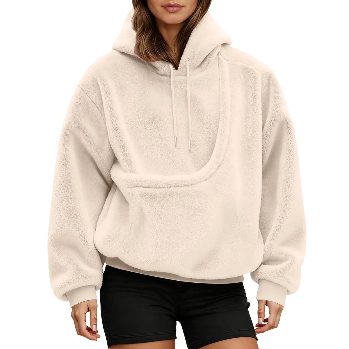 Front view of a cream fluffy hoodie on a model, showing the empty curved kangaroo pouch and drawstring hood. 11