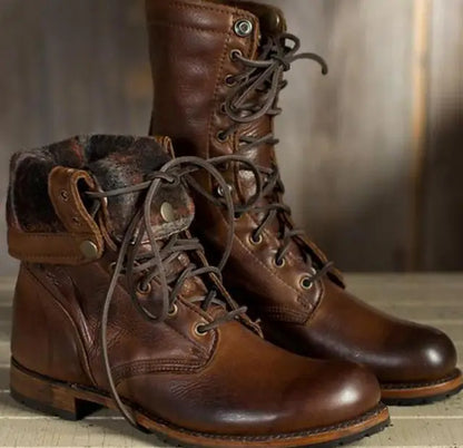 Pair of brown leather lace-up boots, one with its patterned lined cuff folded down, showing the laces and stitched leather. 3