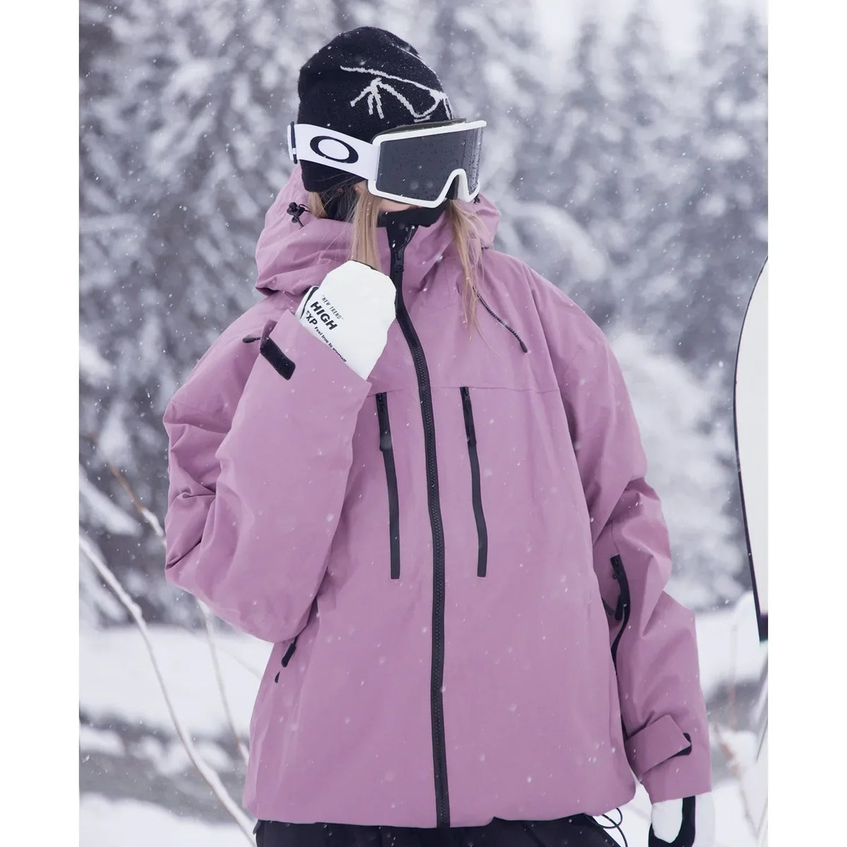 Close-up of the dusky pink jacket on a model, showing the chest zip pockets, hood drawcords and sleeve pocket. 4
