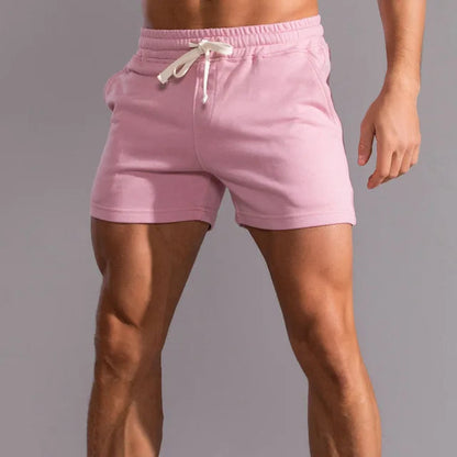 Pink shorts with a white drawstring and side pockets, worn by a model, shown from the front. 6