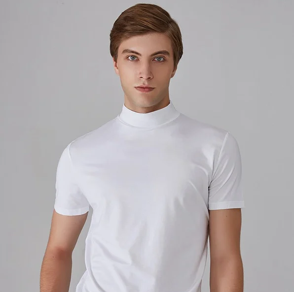 Front view of a model in the white short-sleeved stand-up collar top, looking straight at the camera against a grey background. 3