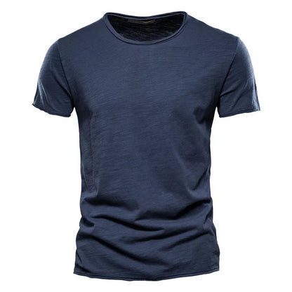 Front view of the short-sleeved crew-neck t-shirt in dark navy blue, showing the textured slub fabric and raw-edged neckline. 2