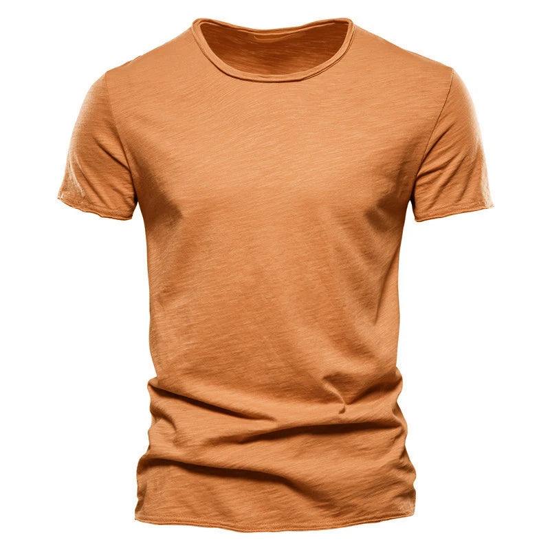 Front view of the short-sleeved crew-neck t-shirt in burnt orange, showing the slub-textured cotton-style fabric and raw-edged finish. 5