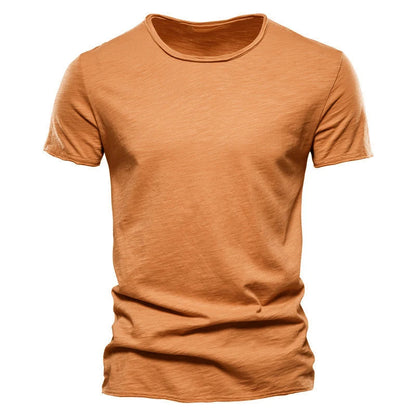Front view of the short-sleeved crew-neck t-shirt in burnt orange, showing the slub-textured cotton-style fabric and raw-edged finish. 5