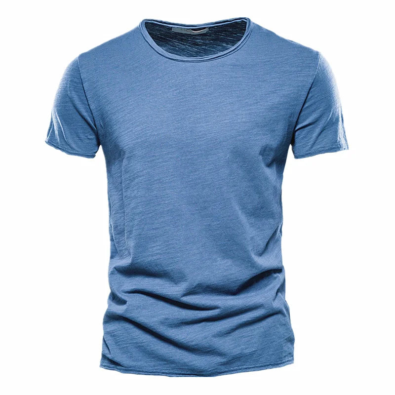 Front view of the short-sleeved crew-neck t-shirt in mid blue, laid flat with a textured fabric and raw-edged neckline. 8