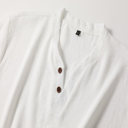 Close-up flat lay of the white top's V-neck collar, two brown four-hole buttons, stitched placket and small size label. 5