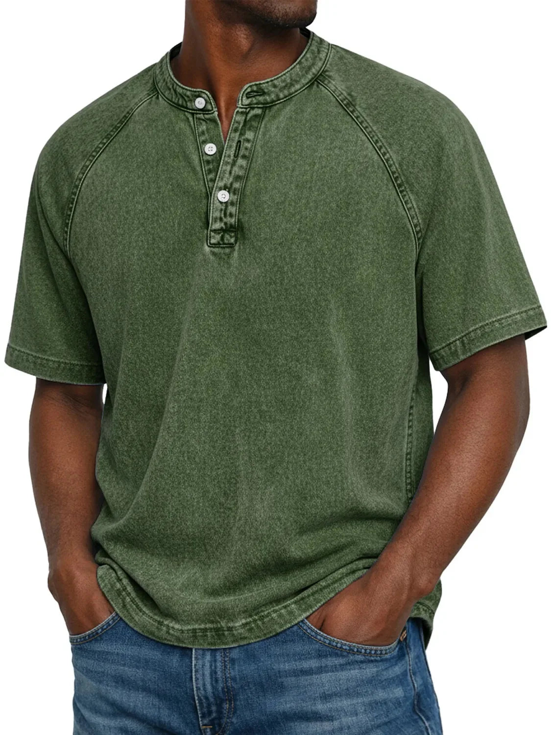Closer, taller crop of a man in the washed dark olive green raglan Henley with button placket, hands in jeans pockets. 16