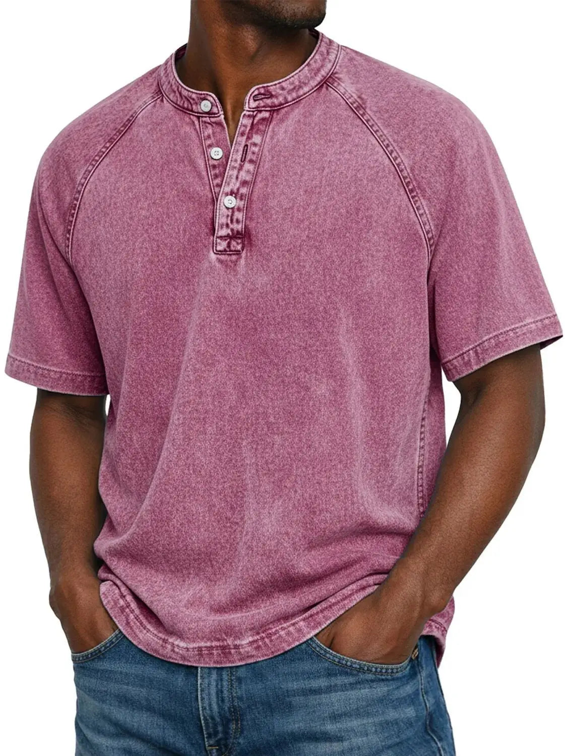 Closer, taller crop of a man in the washed raspberry pink raglan Henley with button placket, hands in jeans pockets. 19