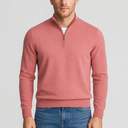 Man wearing a coral pink quarter-zip knit jumper with ribbed cuffs, tucked slightly into blue jeans, front view. 14
