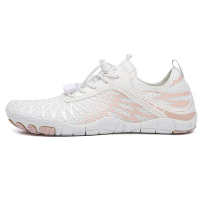 Side view of a white mesh barefoot shoe with pale pink accents, toggle laces and a heel pull loop. 2