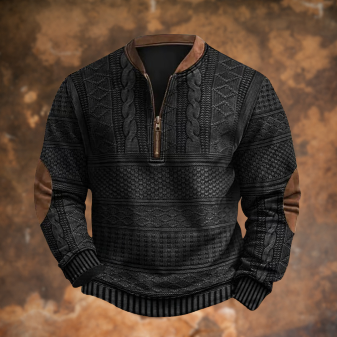 Front view of the quarter-zip jumper in black, showing the textured cable knit panels, brown suede-look collar and elbow patches. 2
