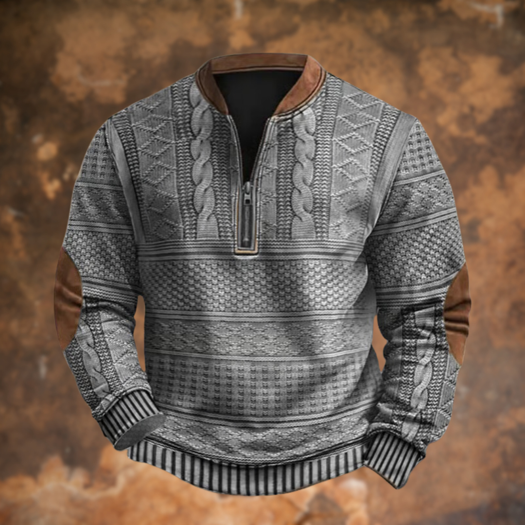 Front view of the quarter-zip jumper in light grey, with cable and diamond patterns, brown collar trim and contrasting brown elbow patches. 5