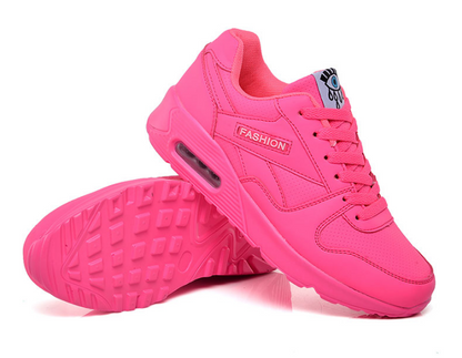 Neon pink trainer shown from the side with the other turned over to reveal its chunky tread sole 7