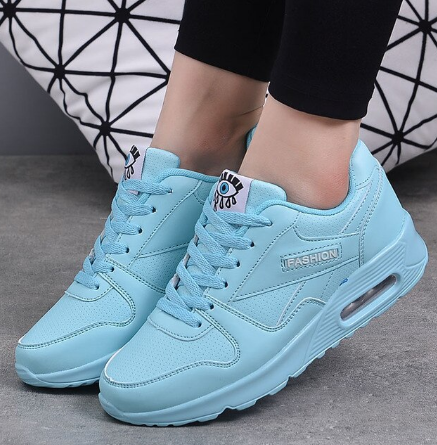 Worn view of light blue trainers with an air cushion heel and matching blue laces 8