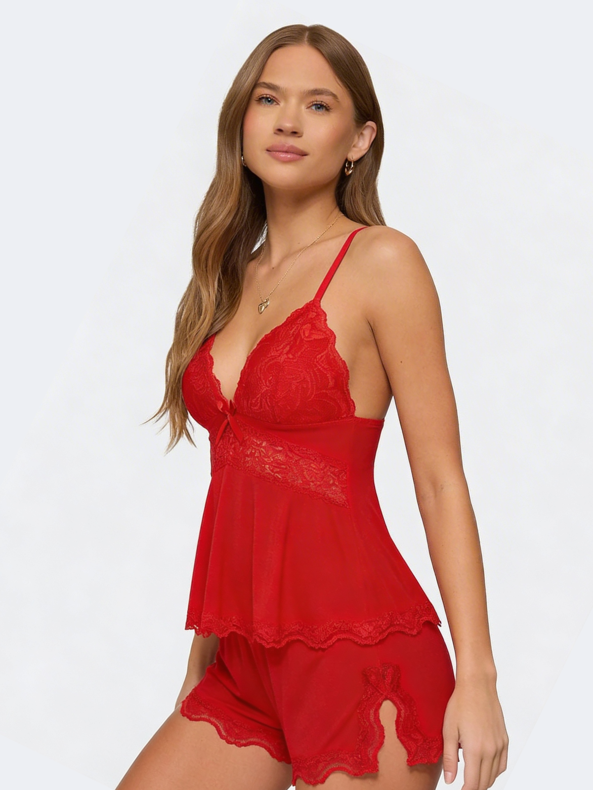 Three-quarter view of the red set on a model, showing the lace side slit on the shorts 22
