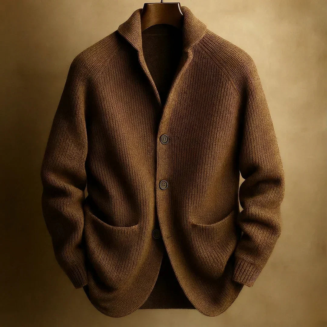 Dark olive-brown ribbed knit cardigan with patch pockets, shown on a hanger against a muted gold backdrop 7