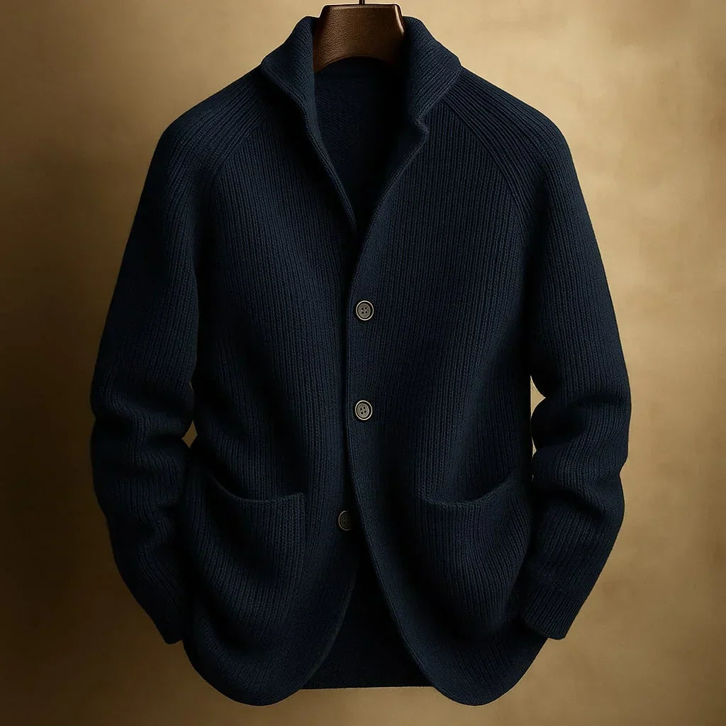 Navy blue ribbed knit cardigan with shawl collar and two front pockets on a hanger 3