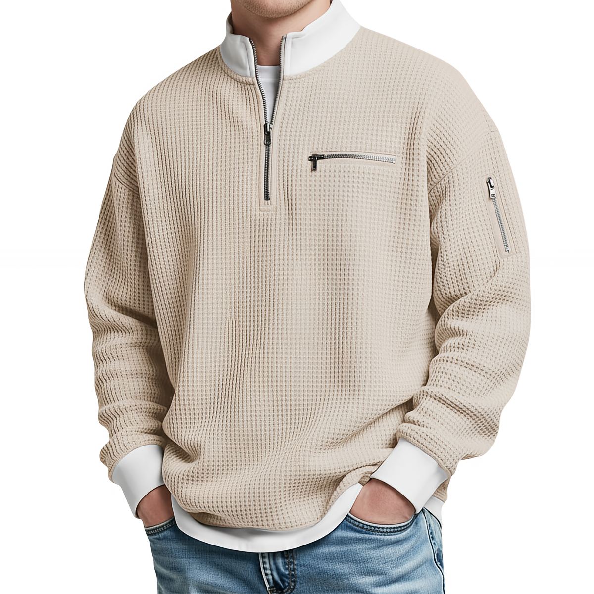 Front view of the beige waffle-knit jumper worn with jeans, with white contrast collar, ribbed cuffs and zipped chest pocket. 5