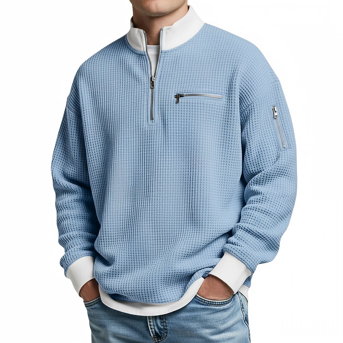 Front view of the light blue waffle-knit jumper worn with jeans, showing the white collar, chest zip pocket and sleeve zip pocket. 4