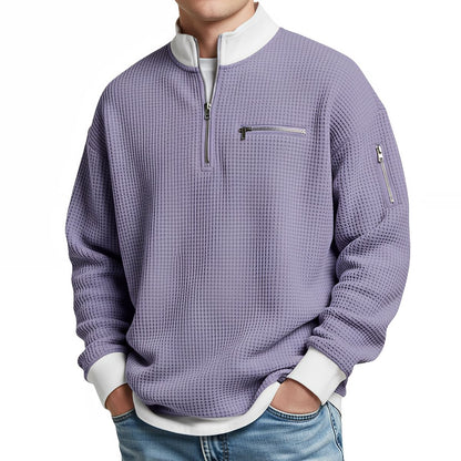Front view of the lavender purple waffle-knit jumper on a model, showing the white collar, half zip and zipped chest pocket. 10
