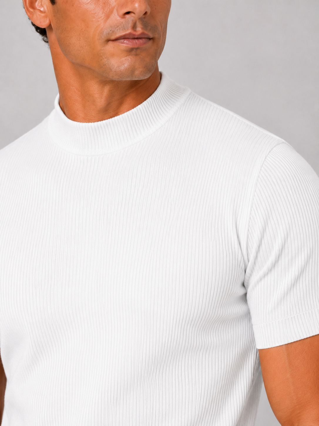 Close-up of the white top's vertical ribbed texture, mock neck collar and short sleeve cuff. 12
