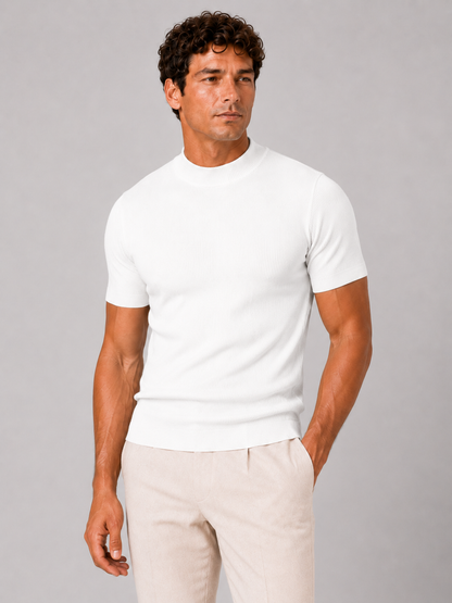 Front view of the white ribbed mock neck top, fitted on the model and paired with cream trousers. 11