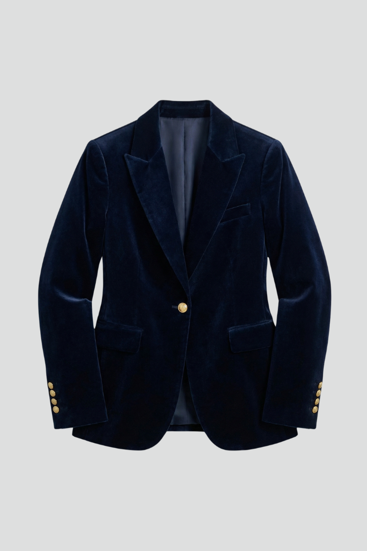 Navy velvet blazer laid flat from the front, showing peaked lapels, one gold button and flap pockets 1
