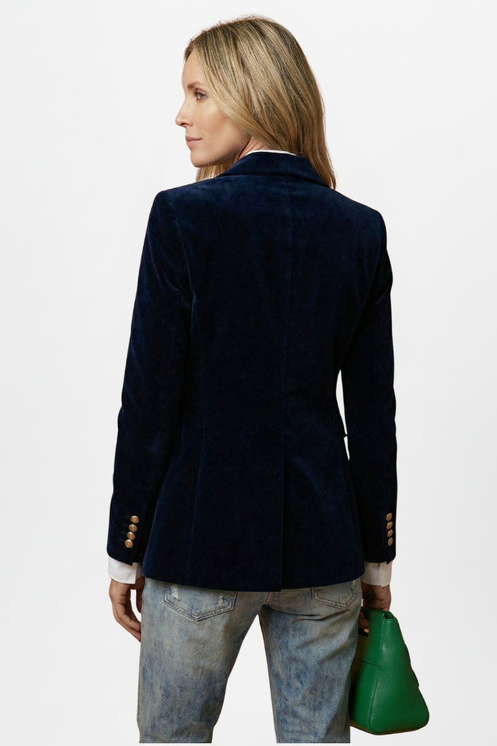 Back view of the navy velvet blazer on a model, showing four gold buttons on each cuff 4