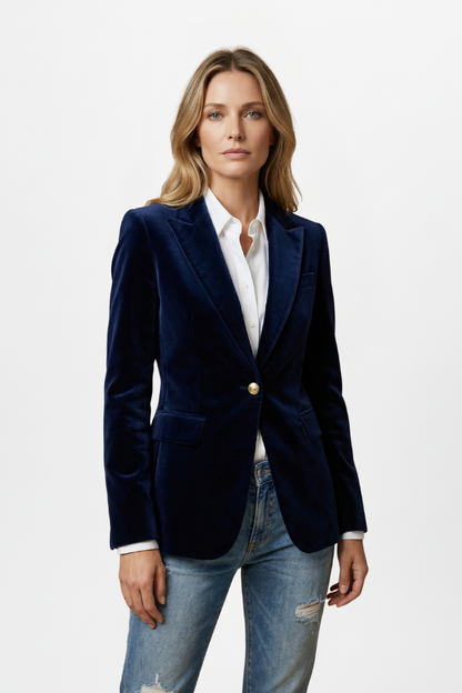 Model faces the camera in the navy velvet blazer, buttoned once, over a white shirt and jeans 6