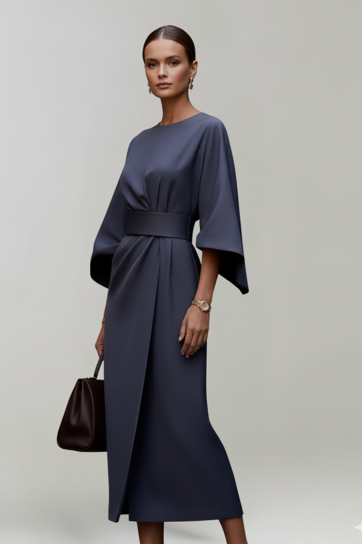Model in the navy dress turned at an angle, showing the wrap skirt opening 3