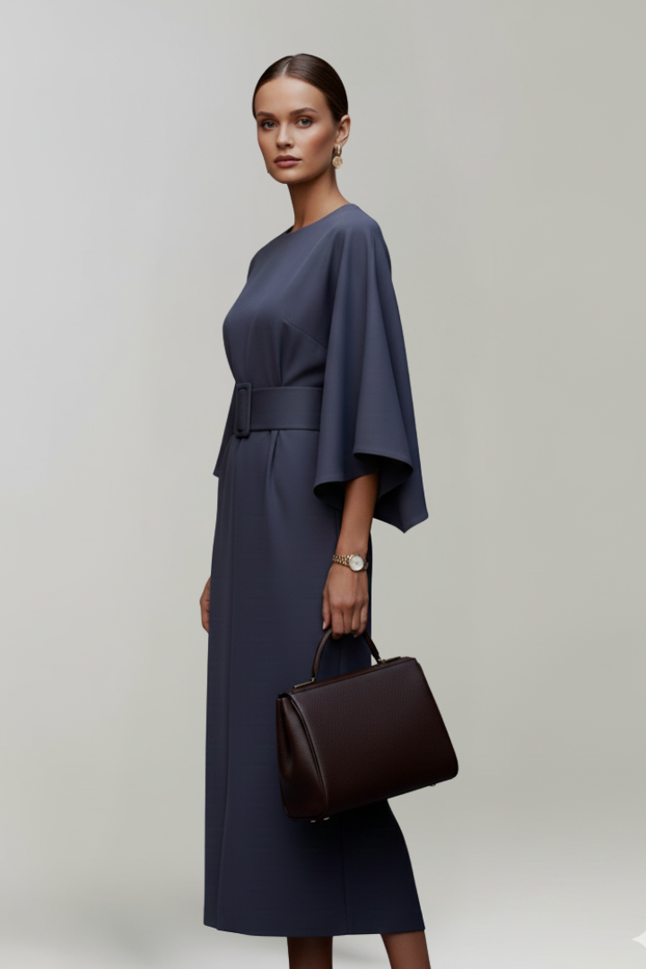 Side view of the navy dress, showing the belt buckle and flared elbow-length sleeve 5