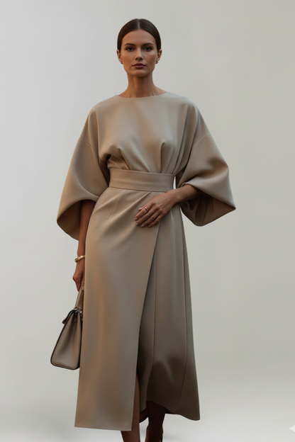 Model wearing the dress in a taupe beige shade, with a matching handbag 6