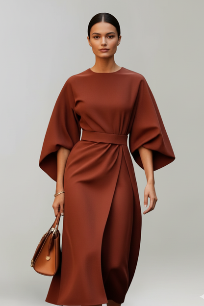 Model wearing the dress in a rust brown shade, with a tan leather handbag 8