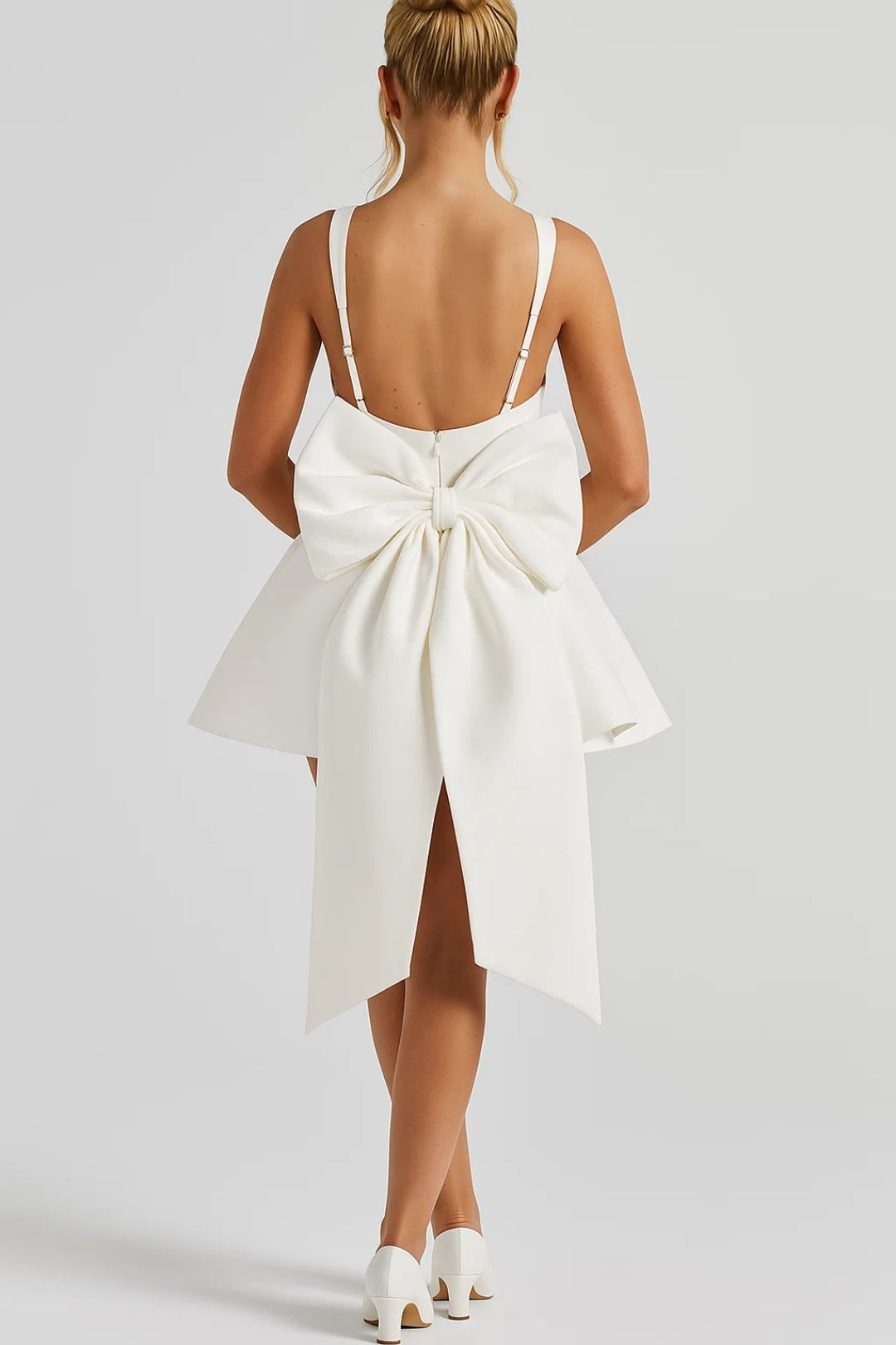 Back view on a model: low open back with thin straps, large cream bow and long tails 4