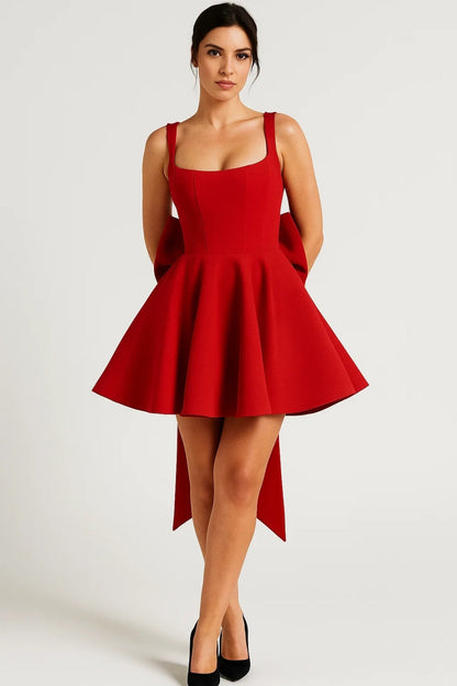 Model wearing the dress in red with black heels, long bow tails falling behind 7