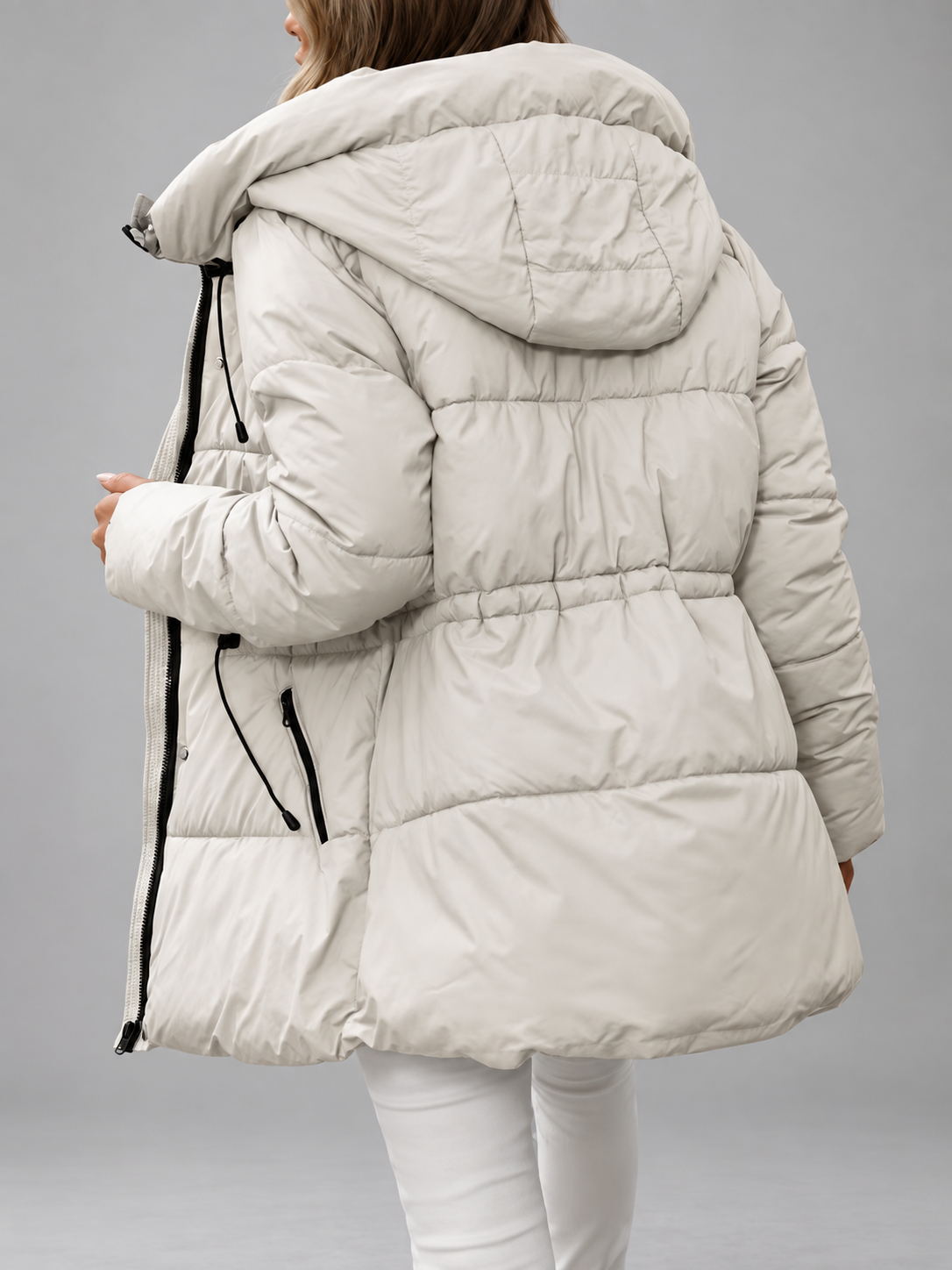 Back view of the cream padded coat showing the hood, gathered waist and quilted panels 9