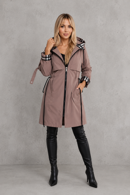 Full-length front view of the mauve coat zipped up, with hand in pocket, side drawcords and checked turned-back cuffs. 7