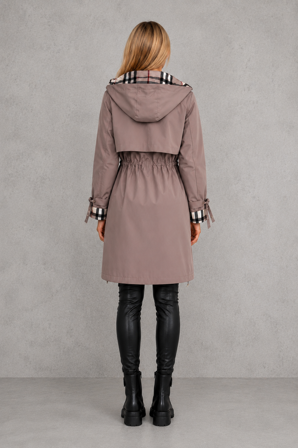 Back view of the mauve hooded coat on a model, showing the gathered waist, back yoke and checked cuff ties. 6
