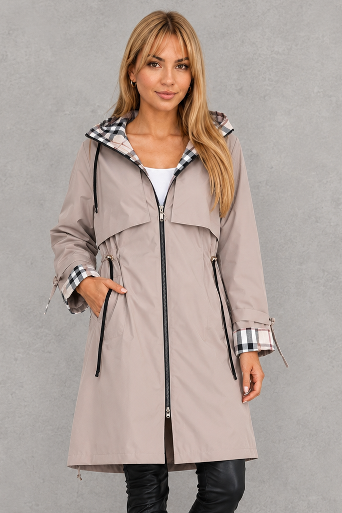 Model wearing the light taupe hooded coat zipped up, with checked hood and cuff lining and a drawcord waist. 2